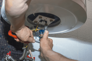 Image of someone servicing a furnace.