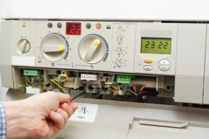 Image of someone working on a furnace. When should you replace your furnace?