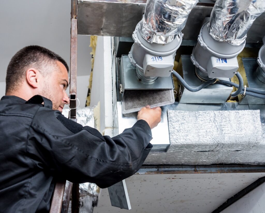 Ventilation cleaning. Specialist at work. Repair ventilation system (HVAC) Tech cleaning air duct system and removing dirty filter