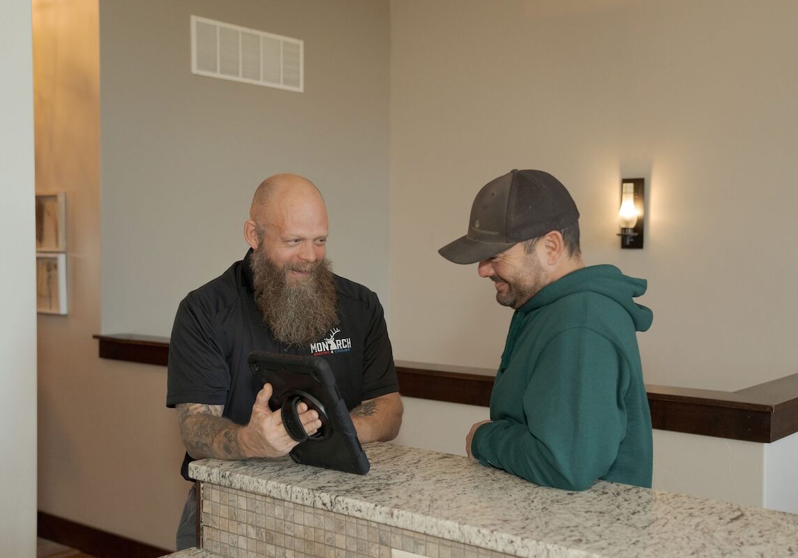 certified tech with customer Certified monarch technician discusses project with customer