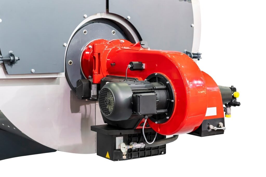 Close up electric motor and blower burner head unit of boiler chamber