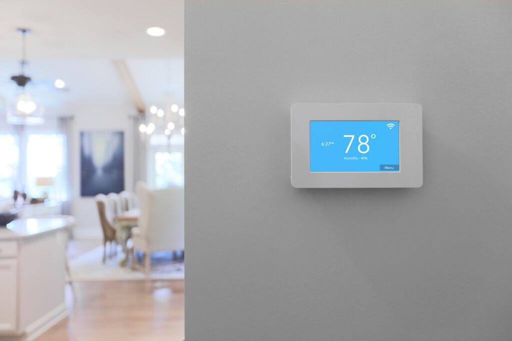 Home with smart thermostat mounted on wall with touchscreen Thermostat on wall on home